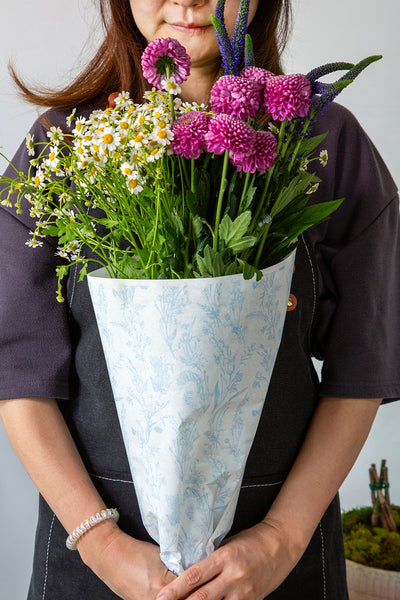 Flower bouquet wrapped in printed tissue paper
